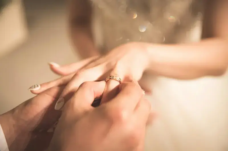 A ring being placed on the bride's finger