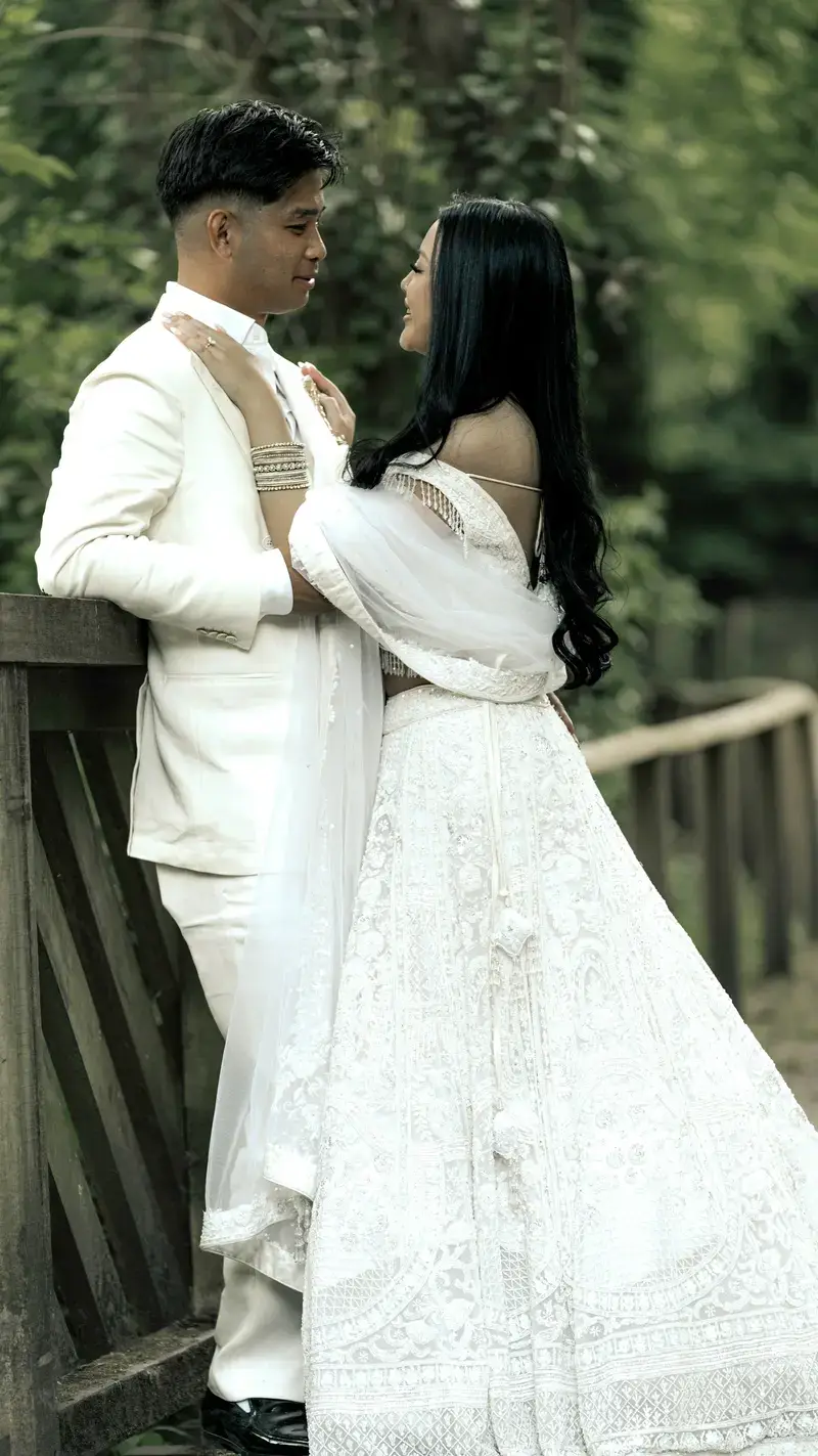 The couple in white attire gazing lovingly at each other
